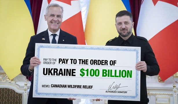 Canada Prime Minister Mark Carney and Ukraine President Zelensky holding a large check for the Canadian wildfires.