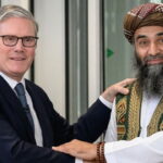 UK Prime Minister Keir Starmer shaking hands with Pakistani male Muslim grooming gang member.