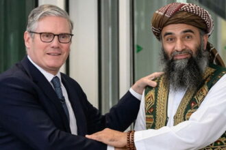 UK Prime Minister Keir Starmer shaking hands with Pakistani male Muslim grooming gang member.