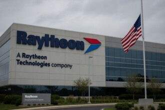 Raytheon building with an American flag at half-mast in memory of deceased Lindsey Graham.
