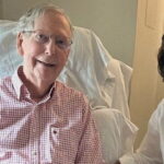 Mitch McConnell in the hospital on a chair sitting next to his Chinese wife.
