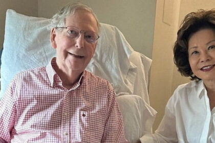 Mitch McConnell in the hospital on a chair sitting next to his Chinese wife.