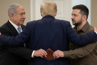 Benjamin Netanyahu and Volodymyr Zelensky hugging President Donald Trump inside of White House.