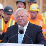 Canada's Doug Ford standing in front of Canadian workers.