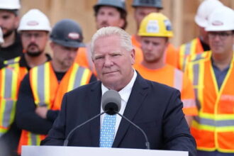 Canada's Doug Ford standing in front of Canadian workers.