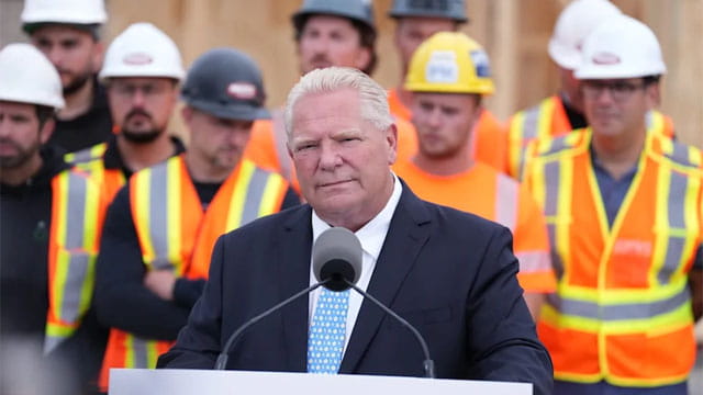 Canada's Doug Ford standing in front of Canadian workers.
