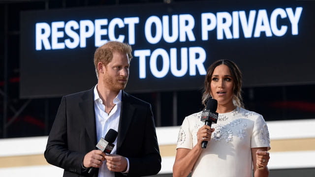 Prince Harry and Meghan Markle Giving a speech on stage.