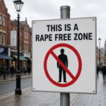 A sign on a pole on a UK British city street.