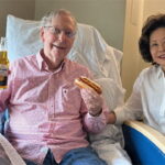 Mitch McConnell photo of him holding a hot dog next to his Chinese wife on Labor Day.
