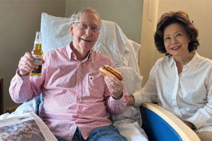 Mitch McConnell photo of him holding a hot dog next to his Chinese wife on Labor Day.