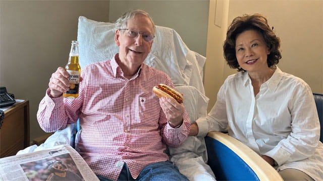 Mitch McConnell photo of him holding a hot dog next to his Chinese wife on Labor Day.