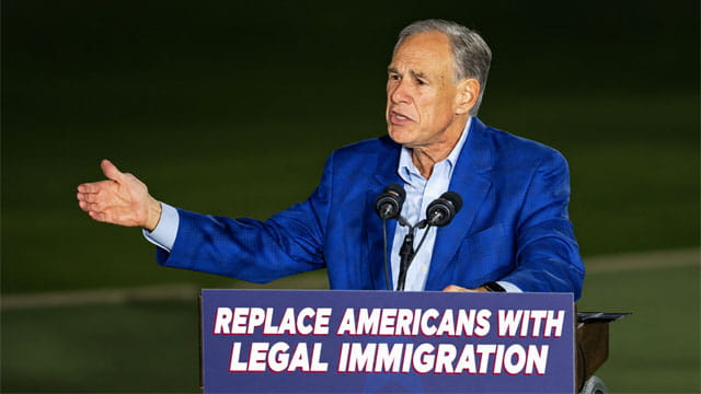 Republicans Greg Abbott on stage giving a speech on immigration.