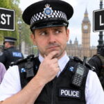 Male UK Police officer thinking with an old grandma on his left and terrorists wearing black to his right.
