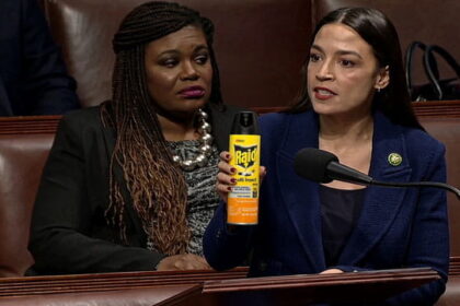 Female Congresswoman AOC holding a can of RAID bug spray inside of Congress speaking.