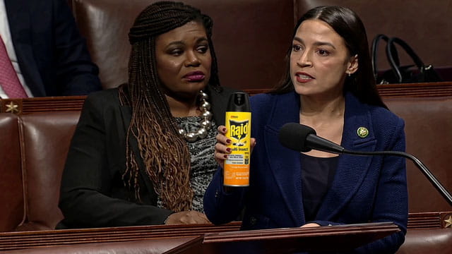 Female Congresswoman AOC holding a can of RAID bug spray inside of Congress speaking.
