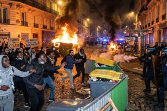 French students and African and Arab migrants rioting and burning buildings during the French student protests in France.