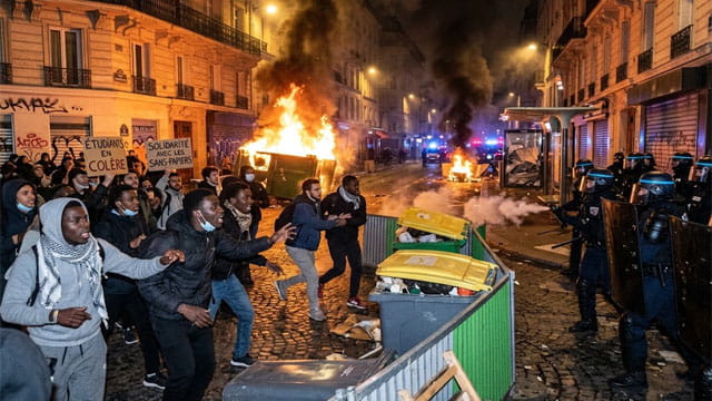 French students and African and Arab migrants rioting and burning buildings during the French student protests in France.