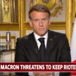 France President Emmanuel Macron giving a speech at a desk on the French riots.