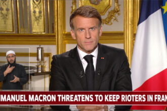 France President Emmanuel Macron giving a speech at a desk on the French riots.
