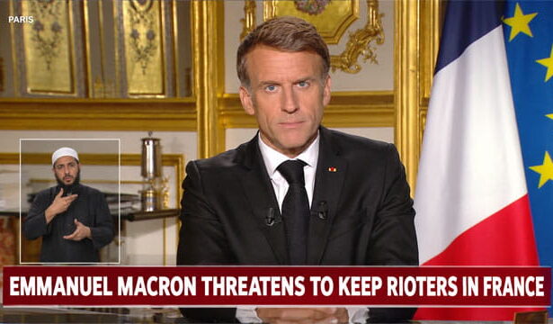 France President Emmanuel Macron giving a speech at a desk on the French riots.