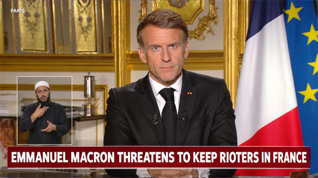 France President Emmanuel Macron giving a speech at a desk on the French riots.