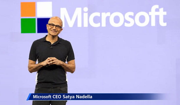 Bald male Indian Microsoft CEO on stage giving a speech.