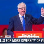 Minnesota Governor Tim Walz giving speech behind podium on Somali gang shooting.