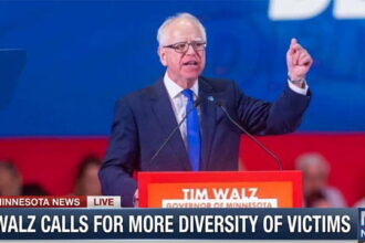Minnesota Governor Tim Walz giving speech behind podium on Somali gang shooting.